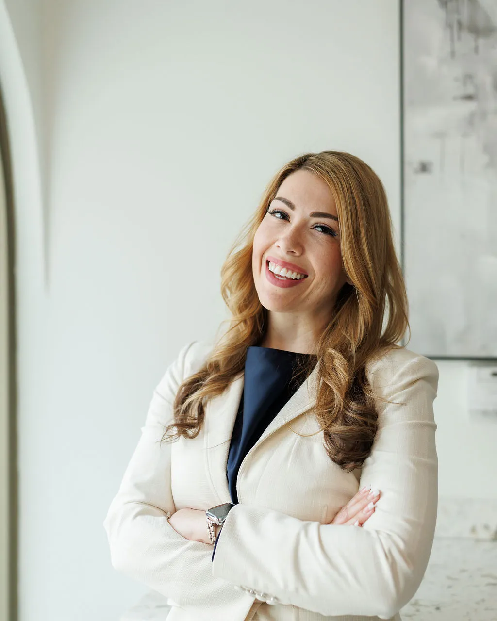 Emily Dawson, co-founder of Avinity Health, smiling in a cream blazer at the Scottsdale clinic